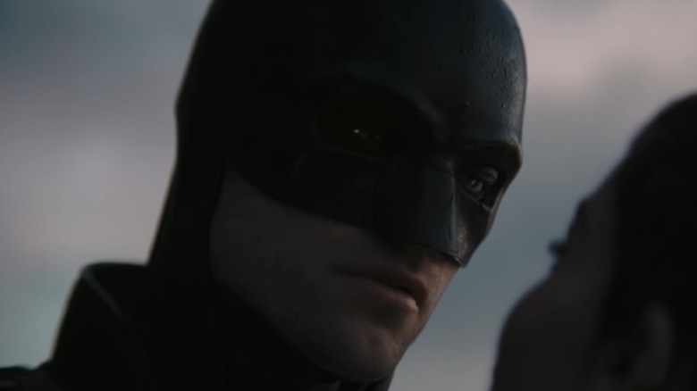 Pattinson as Batman looking into a woman's eyes