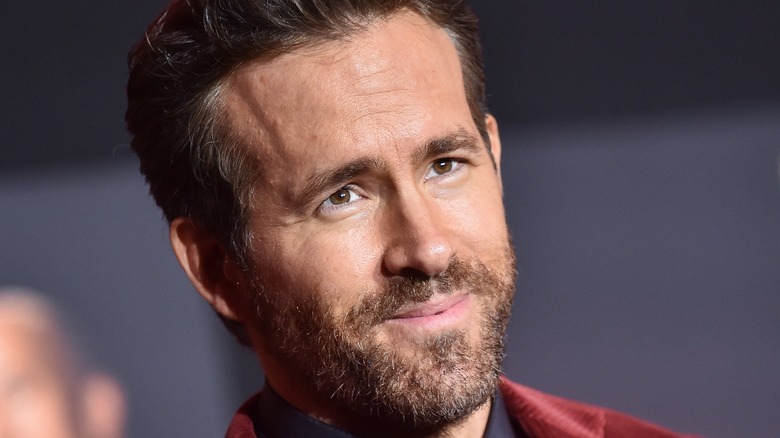 Ryan Reynolds looking off camera and smiling 