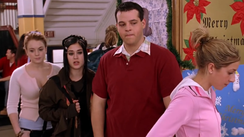 Cady, Janis and Damian stand in line