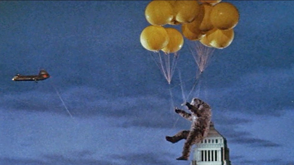 King Kong hanging from balloons