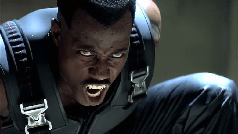 Wesley Snipes as Blade kneels and bares his fangs