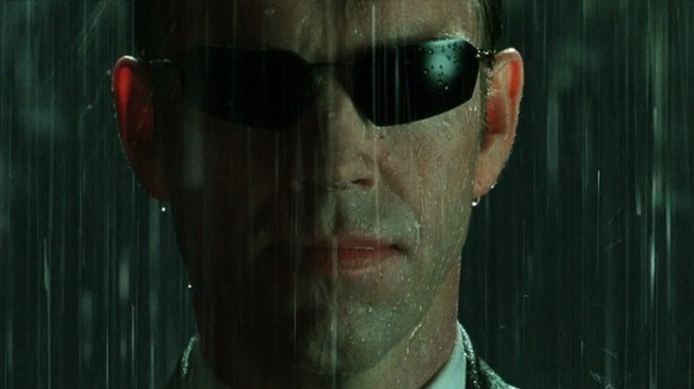 Agent Smith in the rain with sunglasses