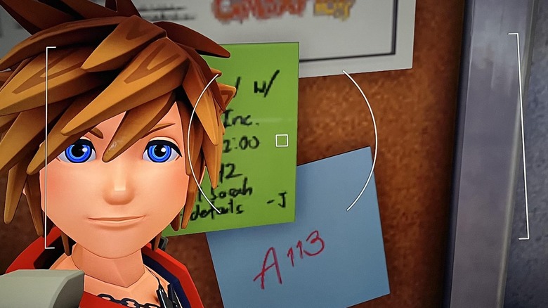 Sora selfie in front of bulletin board