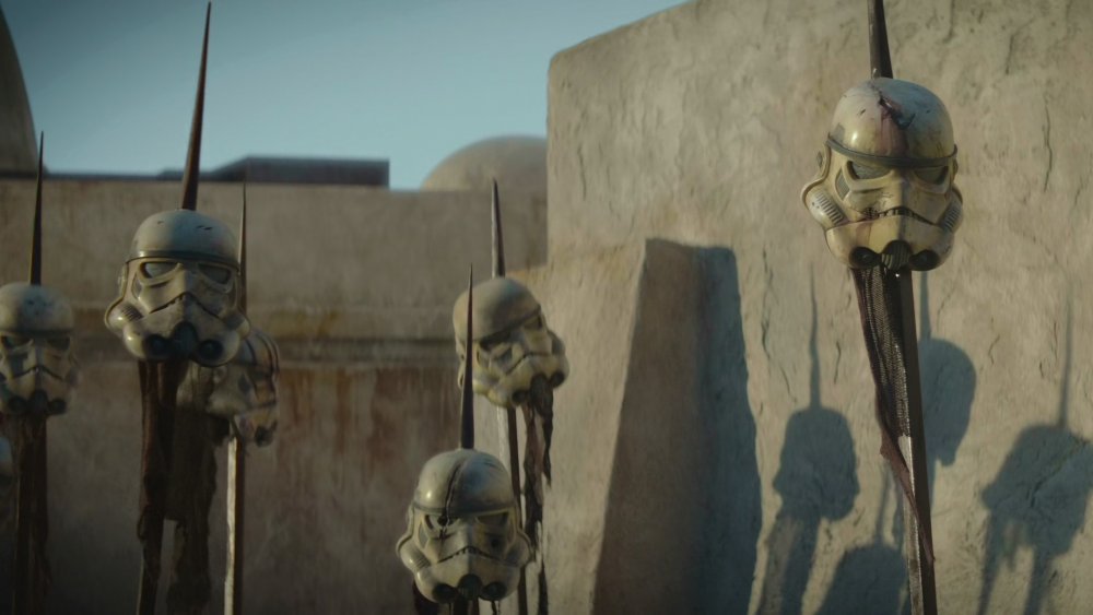 Imperial Stormtrooper helmets on pikes in Mos Eisley after the end of the Galactic Civil War