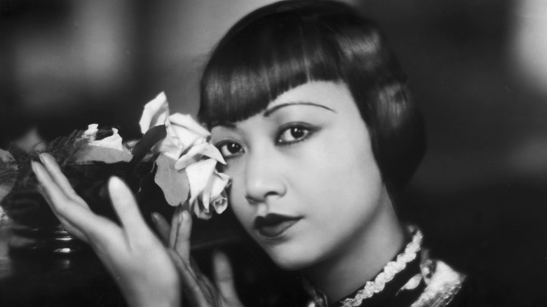 Anna May Wong holding rose