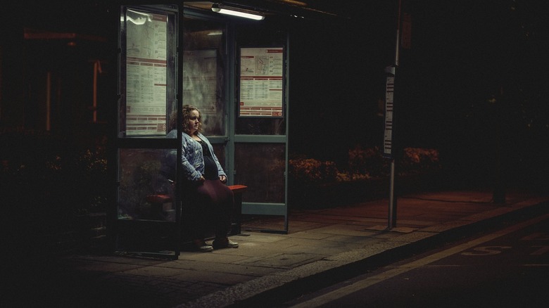 Martha alone at bus stop