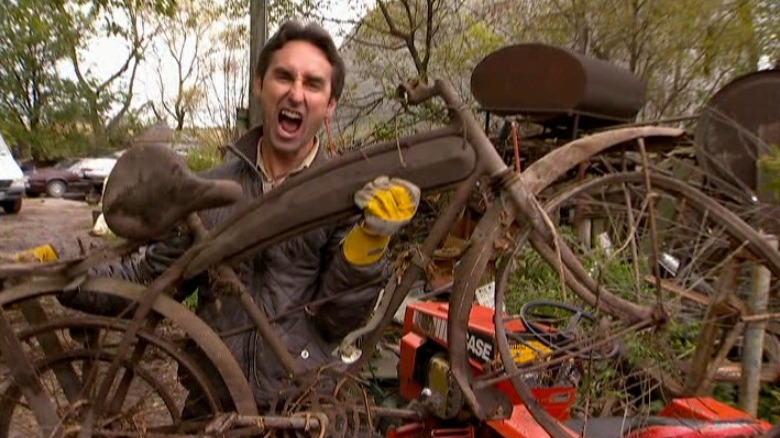 Mike Wolfe holds up a vintage bicycle