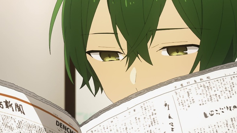 Shu Iura reading newspaper