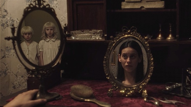 Reflections of the twins and Lola in two mirrors