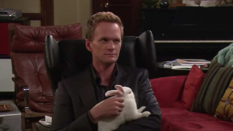 Barney holds bunny in chair 