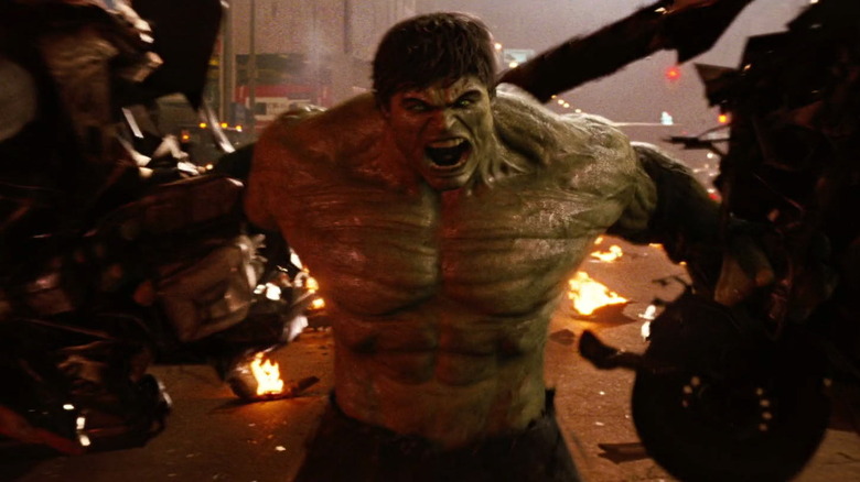 Hulk holding pieces of a car