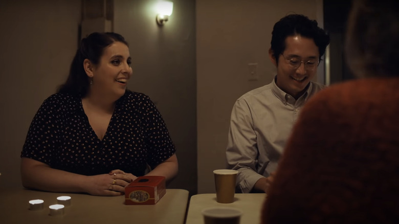 Beanie Feldstein and Steven Yeun laughing