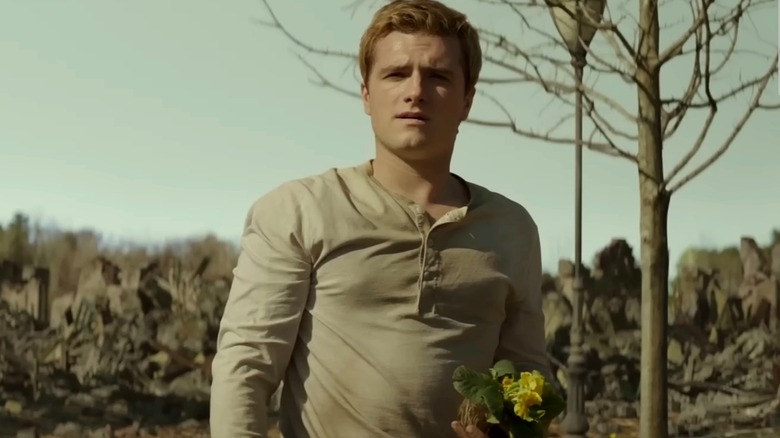 Peeta holding flowers in Mockingjay Part 2