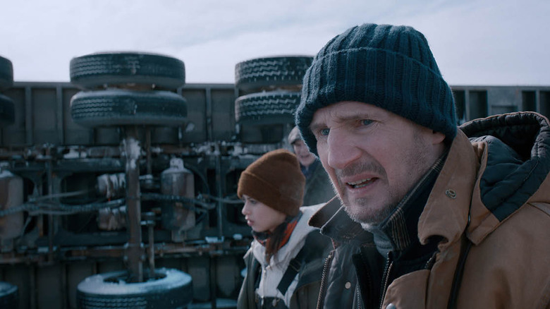 Mike and others standing by an overturned truck