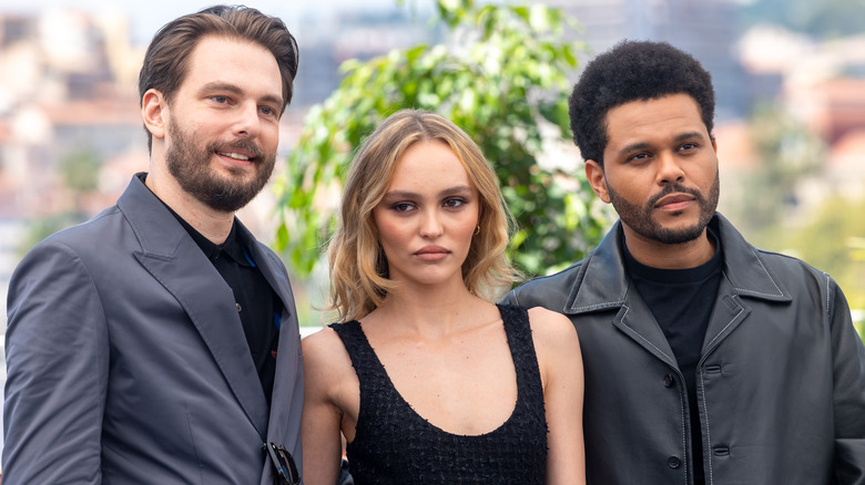 Sam Levinson, Lily-Rose Depp, and The Weeknd posing 