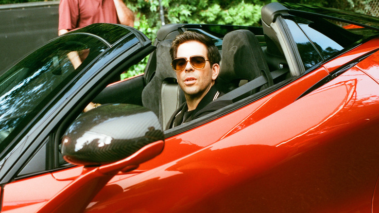 Andrew driving red car