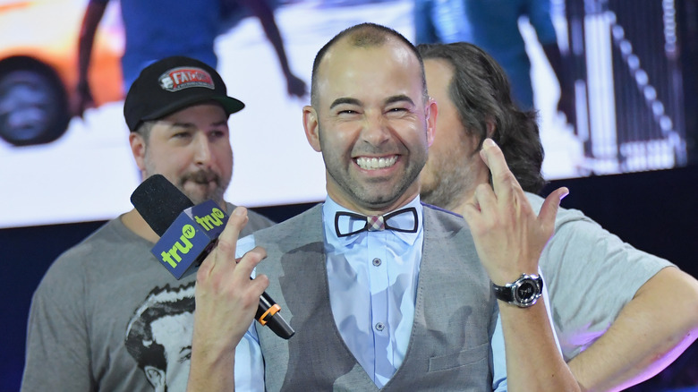 James Murray smiling and pointing