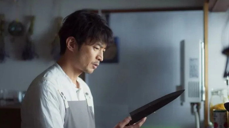 Kenjiro Tsuda staring at knife