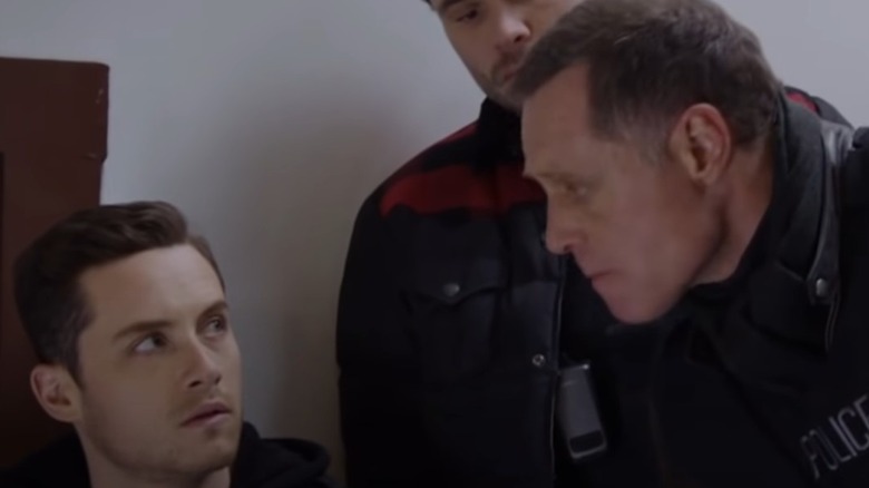 Jesse Lee Soffer and Jason Beghe in hallway