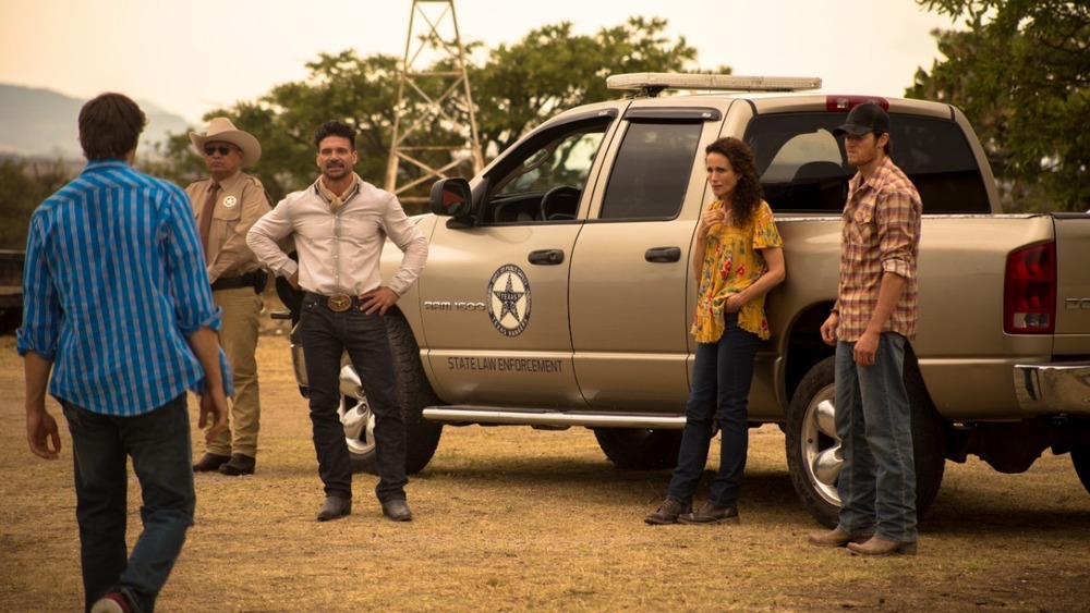 The Greer family around a pickup truck