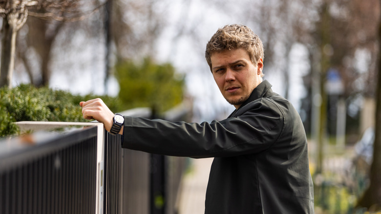 Bilski leaning on fence