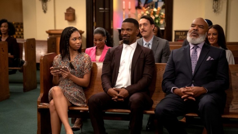 Jamie Foxx in church pew smiling