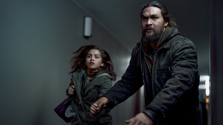 Isabela Merced and Jason Momoa running