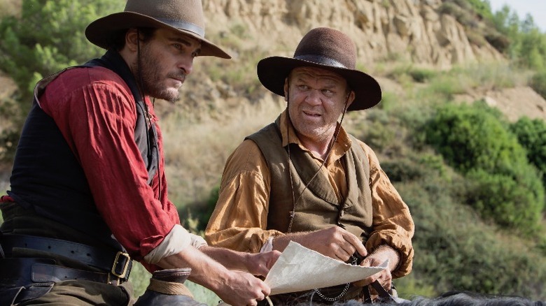 John C. Reilly as Eli Sisters and Joaquin Phoenix as Charlie Sisters in "The Sisters Brothers"