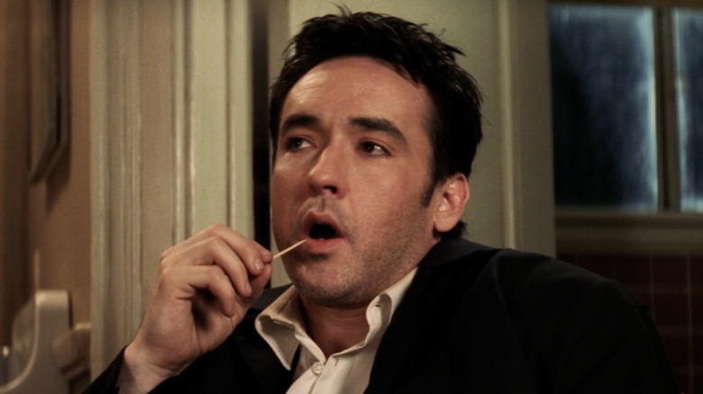 John Cusack uses toothpick