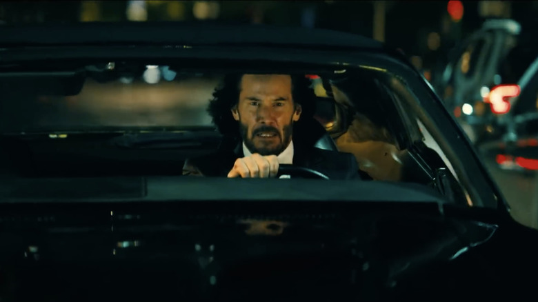 Keanu Reeves driving muscle car