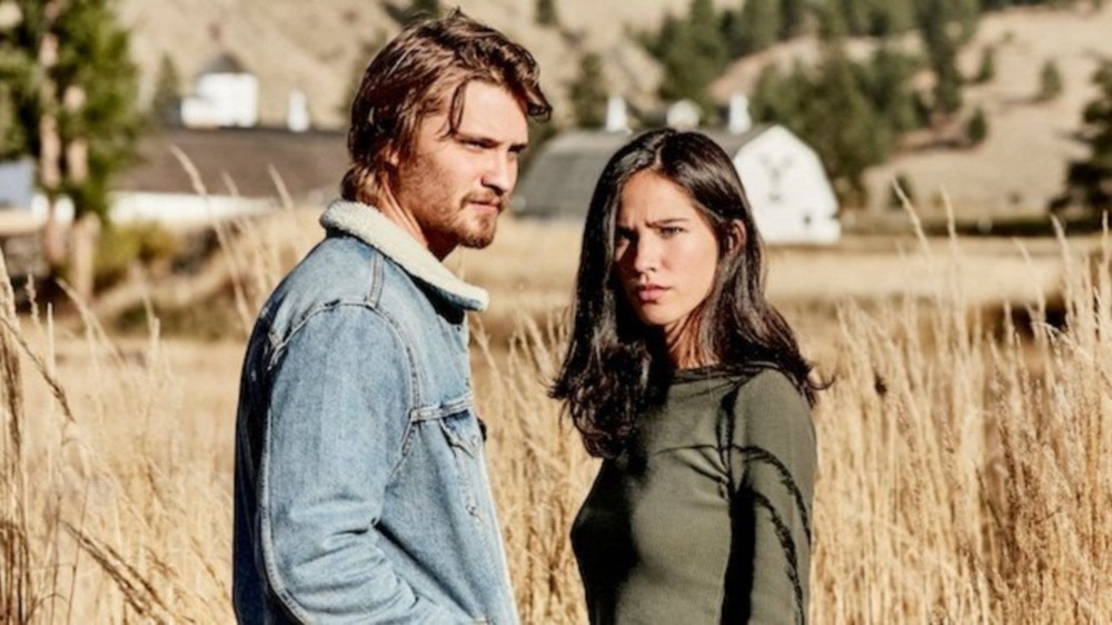 Kayce and Monica stand in a field on Yellowstone