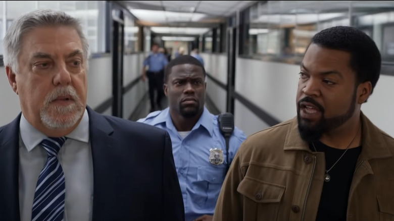 James and Ben walking through hallway with Lieutenant Brooks