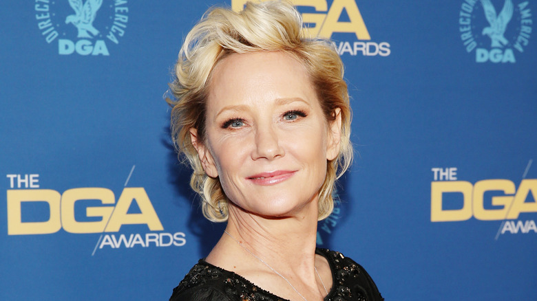 Anne Heche smiling wearing black