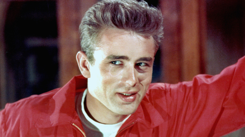 James Dean smiling in red jacket