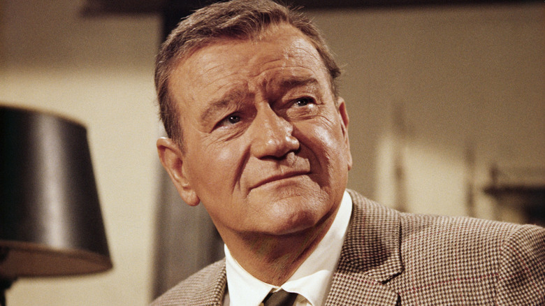 John Wayne wearing brown suit