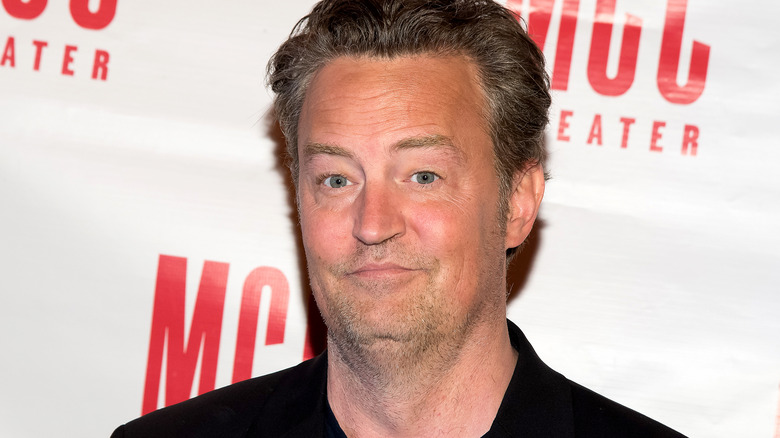 Matthew Perry smiling in black