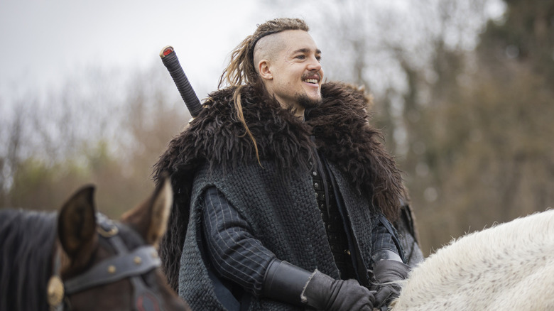 Uhtred smiling and riding horse