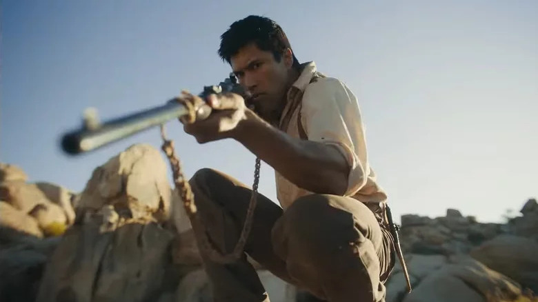 Martin Sensmeier holds rifle