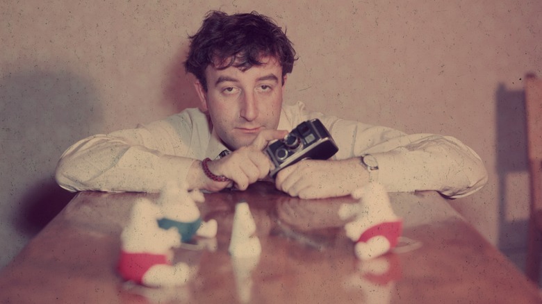 Peter Sellers holding a camera