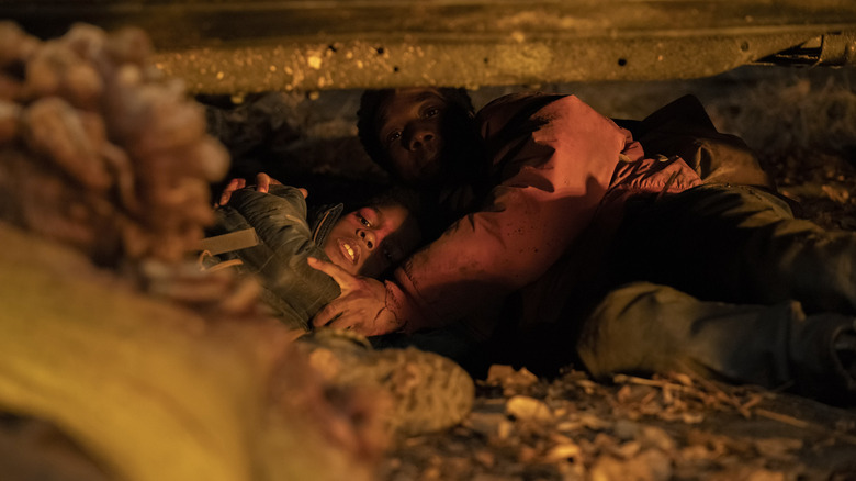 Frightened Henry and Sam lay under car