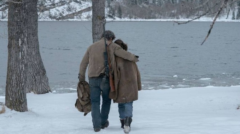 Joel and Ellie walk through the snow