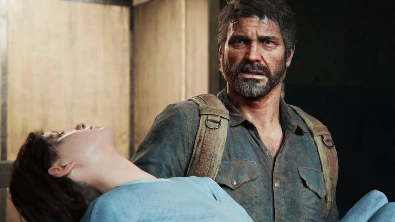 Joel carrying Ellie in The Last of Us game