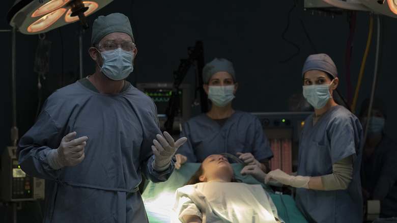 Doctor and nurses operating on Ellie