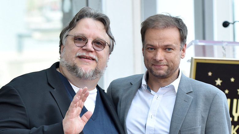 Guillermo del Toro stands next to André Øvredal