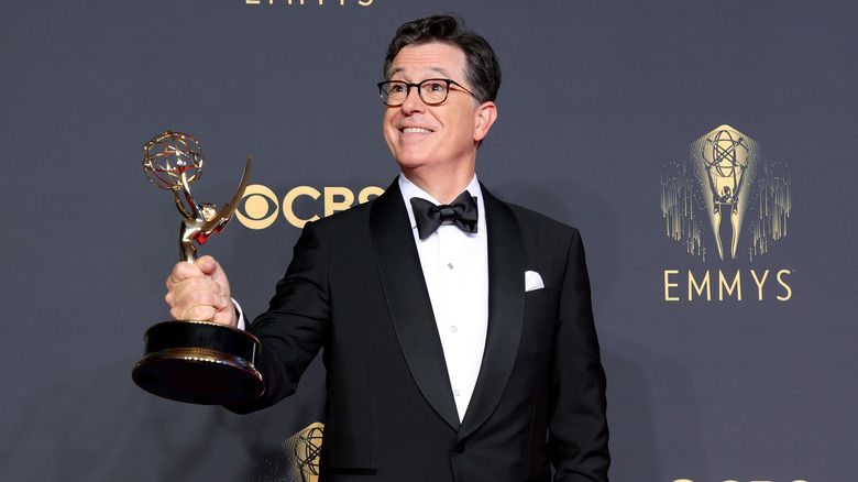 Stephen Colbert holding Emmy