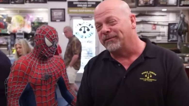 Rick Harrison stands beside Spider-Man figure