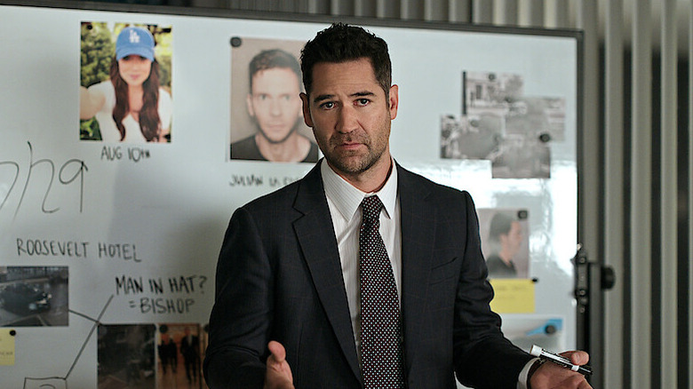 Haller stands in front of a whiteboard in "The Lincoln Lawyer" (2022-present)