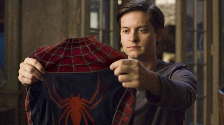 Tobey Maguire holding the Spider-suit