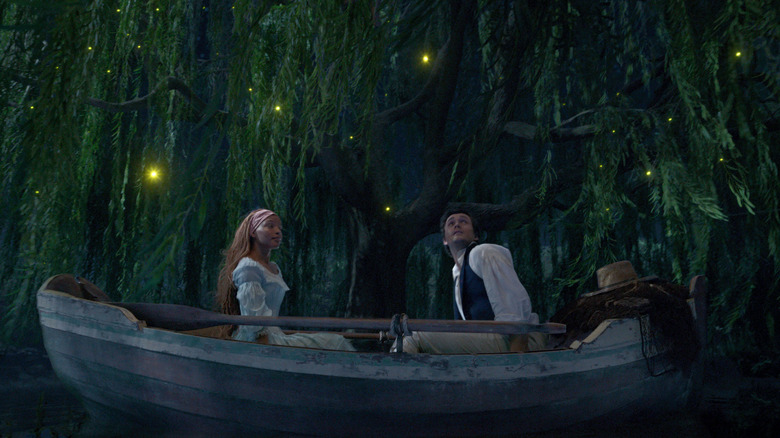 Ariel and Prince Eric on a boat ride lit by fireflies