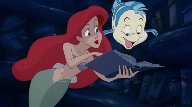 Ariel shows Flounder her book in The Little Mermaid (1989)